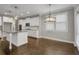 Open kitchen features stainless steel appliances, hardwood floors, and a modern light fixture at 4204 Hardy Ave, Smyrna, GA 30082