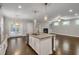 Open concept kitchen with island, stainless steel appliances and access to the living area at 4204 Hardy Ave, Smyrna, GA 30082