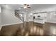 Open concept living area with stairs and a kitchen island featuring modern lighting fixtures at 4204 Hardy Ave, Smyrna, GA 30082