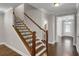 Elegant staircase featuring hardwood steps, iron railings, and neutral decor at 4204 Hardy Ave, Smyrna, GA 30082