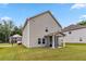 Backyard with a covered patio, green grass, and view of a two-story home at 6094 Whitetail Deer Run, Mableton, GA 30126