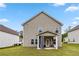 Backyard view of a home featuring a covered patio area and spacious yard at 6094 Whitetail Deer Run, Mableton, GA 30126