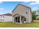 Backyard with large green space, a covered patio, and exterior view of home at 6094 Whitetail Deer Run, Mableton, GA 30126