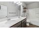 Bathroom with dual sink vanity, a mirror, and a bathtub-shower combination at 6094 Whitetail Deer Run, Mableton, GA 30126