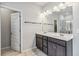 Modern bathroom with double vanity, a large mirror, and a shower with glass door at 6094 Whitetail Deer Run, Mableton, GA 30126