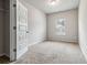 This empty bedroom has neutral carpet, a window and a closet at 6094 Whitetail Deer Run, Mableton, GA 30126