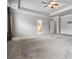 Spacious bedroom with neutral walls, carpet floor, ceiling fan, and entrance to the bathroom at 6094 Whitetail Deer Run, Mableton, GA 30126