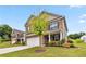 Beautiful two-story brick home featuring a lush green lawn and neatly landscaped flowerbeds at 6094 Whitetail Deer Run, Mableton, GA 30126