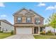 Charming two-story brick home with a well-manicured lawn and attached two-car garage at 6094 Whitetail Deer Run, Mableton, GA 30126