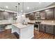 Bright kitchen with granite countertops, stainless steel appliances, a tiled backsplash and dark brown cabinets at 6094 Whitetail Deer Run, Mableton, GA 30126