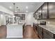 The kitchen boasts granite countertops, stainless appliances, tiled backsplash and plenty of dark-brown cabinet space at 6094 Whitetail Deer Run, Mableton, GA 30126