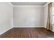 Bright, empty room with hardwood floors, crown molding and large window at 6094 Whitetail Deer Run, Mableton, GA 30126