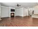 Open-concept living room with hardwood floors, fireplace, and staircase access at 6094 Whitetail Deer Run, Mableton, GA 30126