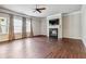 Spacious living room featuring hardwood floors, a ceiling fan, and a cozy fireplace at 6094 Whitetail Deer Run, Mableton, GA 30126