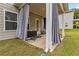 Covered patio with cloth curtains, concrete floor, and outdoor storage at 6094 Whitetail Deer Run, Mableton, GA 30126