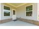 Covered back porch with access door and large windows offering ample natural light at 740 Pineberry Ct, Grayson, GA 30017