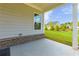 Covered back porch with view of the backyard and neighboring home at 740 Pineberry Ct, Grayson, GA 30017