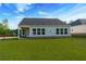 View of backyard from back porch showing landscaping and expansive lawn at 740 Pineberry Ct, Grayson, GA 30017