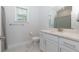 Well-lit bathroom featuring a vanity with a sink, a toilet, and a shower with a gray and white curtain at 740 Pineberry Ct, Grayson, GA 30017