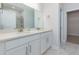 Primary bathroom with double sinks, white cabinets, and a large mirror at 740 Pineberry Ct, Grayson, GA 30017