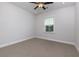 Well-lit bedroom featuring a ceiling fan and a window with blinds for natural light at 740 Pineberry Ct, Grayson, GA 30017