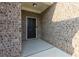 Inviting front entry featuring a solid black door, brick facade, and modern outdoor lighting at 740 Pineberry Ct, Grayson, GA 30017
