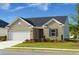 Charming single-story brick home featuring an attached two-car garage and well-manicured front lawn at 740 Pineberry Ct, Grayson, GA 30017