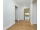 Bright hallway featuring hardwood floors, white trim, and views into the living spaces at 740 Pineberry Ct, Grayson, GA 30017