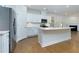 Well-appointed kitchen featuring white cabinets, a stainless steel refrigerator, and a spacious island at 740 Pineberry Ct, Grayson, GA 30017