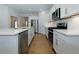 Modern kitchen with white cabinetry, stainless steel appliances, and a large center island with bar seating at 740 Pineberry Ct, Grayson, GA 30017