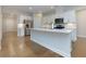 Modern kitchen with white cabinets, stainless steel appliances, and a large central island at 740 Pineberry Ct, Grayson, GA 30017