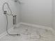 Laundry room with white marble tile flooring and hookups for your washer and dryer at 740 Pineberry Ct, Grayson, GA 30017