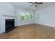 Bright living room with fireplace and large windows overlooking the yard at 740 Pineberry Ct, Grayson, GA 30017