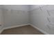 Spacious walk-in closet with wire shelving and carpeted floor, perfect for organizing your wardrobe at 740 Pineberry Ct, Grayson, GA 30017