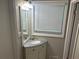 Bathroom vanity features granite countertop, a sink, white cabinets and a mirror at 1093 Hasty Sw Ct, Lilburn, GA 30047