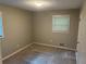 Cozy bedroom features neutral tones and large window at 1093 Hasty Sw Ct, Lilburn, GA 30047