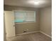 Bedroom with neutral carpet and walls, featuring large windows with natural light at 1093 Hasty Sw Ct, Lilburn, GA 30047