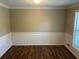 The dining room features sleek flooring, wainscotting details, and a large window at 1093 Hasty Sw Ct, Lilburn, GA 30047