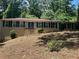 Charming ranch-style home with a brick facade, black shutters and a well-manicured lawn at 1093 Hasty Sw Ct, Lilburn, GA 30047