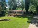 Ranch-style home featuring a well-maintained lawn and traditional architectural details at 1093 Hasty Sw Ct, Lilburn, GA 30047