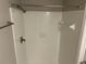 Bathroom shower with white tile and silver shower head, creating a clean space at 1093 Hasty Sw Ct, Lilburn, GA 30047