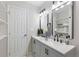 Bathroom featuring a double vanity, modern fixtures, and a tiled shower with recessed shelves at 1770 Atherton Dr, Decatur, GA 30035