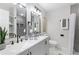 Bathroom featuring a double vanity, modern fixtures, and a tiled shower with recessed shelves at 1770 Atherton Dr, Decatur, GA 30035