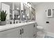 Bright bathroom with double vanity, sleek fixtures, and modern wall art at 1770 Atherton Dr, Decatur, GA 30035