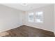 This bedroom has warm-toned wood floors and two large windows at 1770 Atherton Dr, Decatur, GA 30035