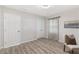 This bedroom features sleek laminate floors, a chair and calming wall art at 1770 Atherton Dr, Decatur, GA 30035