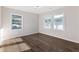 This bedroom is bright with warm-toned wood floors and two large windows at 1770 Atherton Dr, Decatur, GA 30035