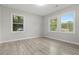 Bright bedroom featuring wood-look flooring, natural light, and neutral paint at 1770 Atherton Dr, Decatur, GA 30035