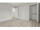 Neutral bedroom featuring light wood floors, walk-in closet, and white doors at 1770 Atherton Dr, Decatur, GA 30035