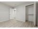 Neutral bedroom featuring light wood floors, walk-in closet, and white doors at 1770 Atherton Dr, Decatur, GA 30035